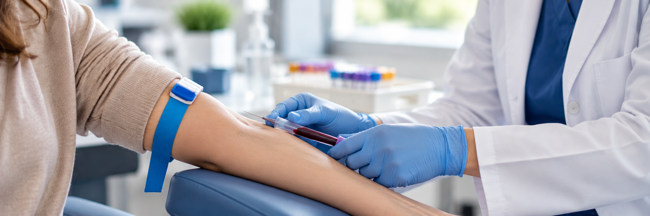 Healthcare professional drawing a blood sample from a patient in a clinic